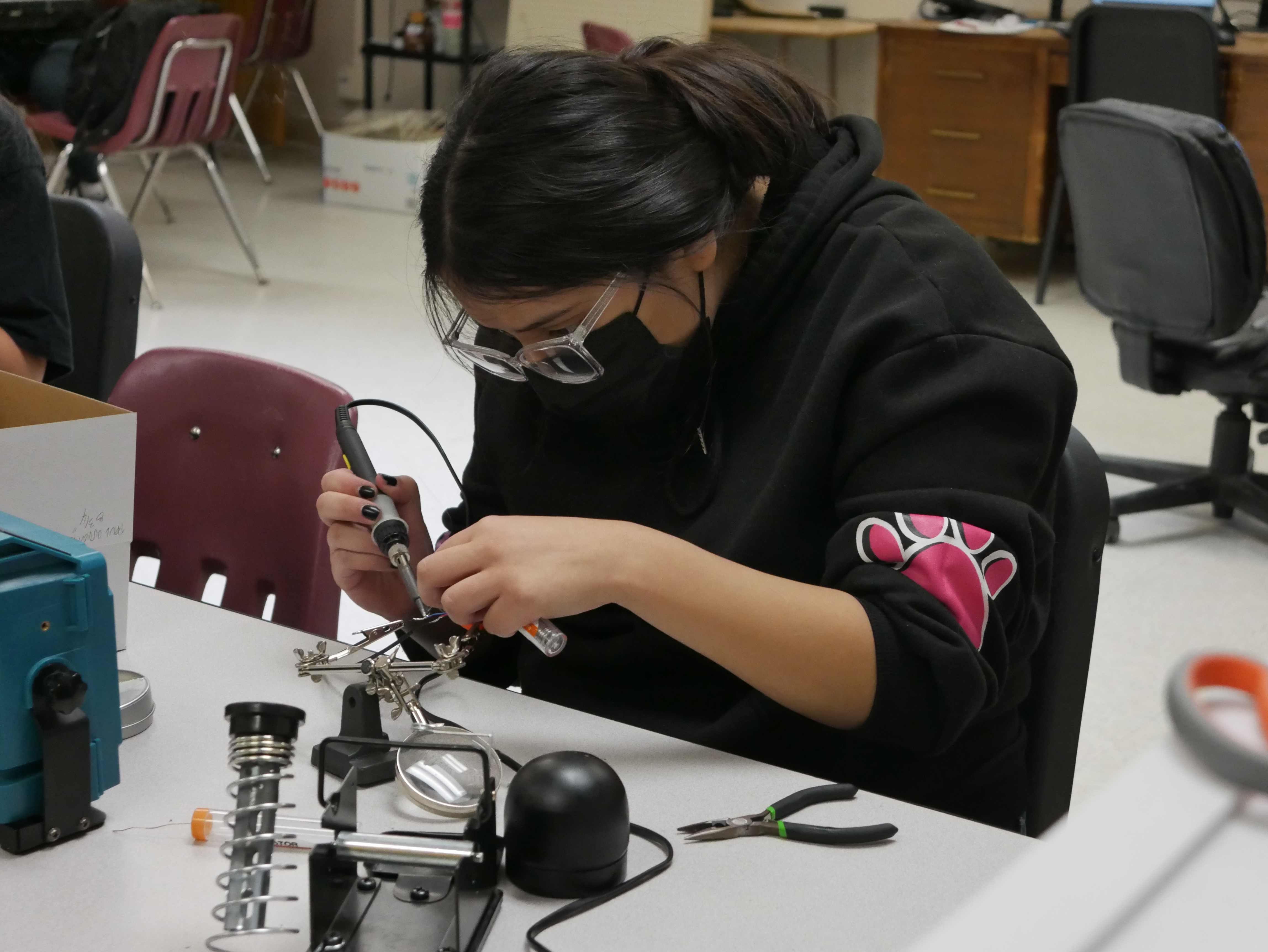 NNMC Engineering student and EVHS MESA Alumni Gabriela Arevalo solders glove components